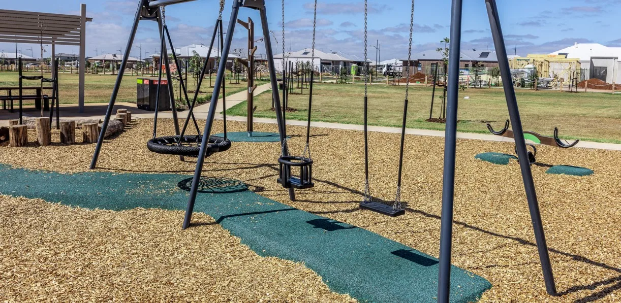 A new playground with swings, and new homes behind it, in Thornhill Park